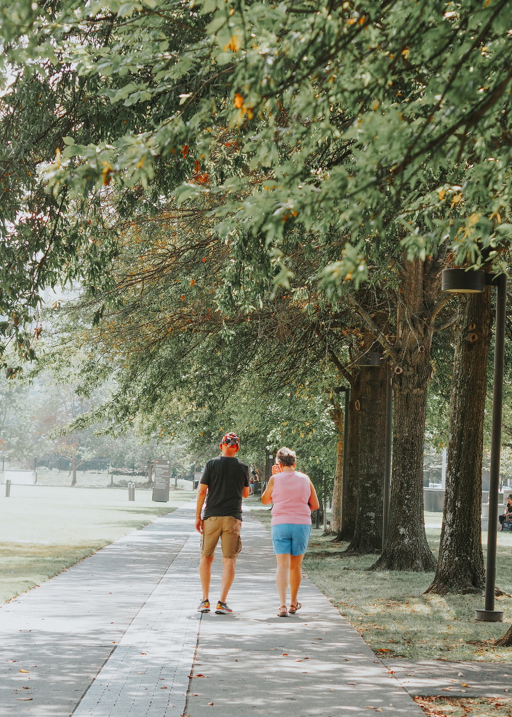 a man and a woman walking down a sidewalk