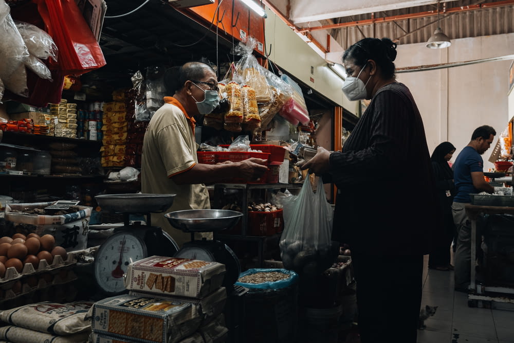 a man and a woman are standing in a market