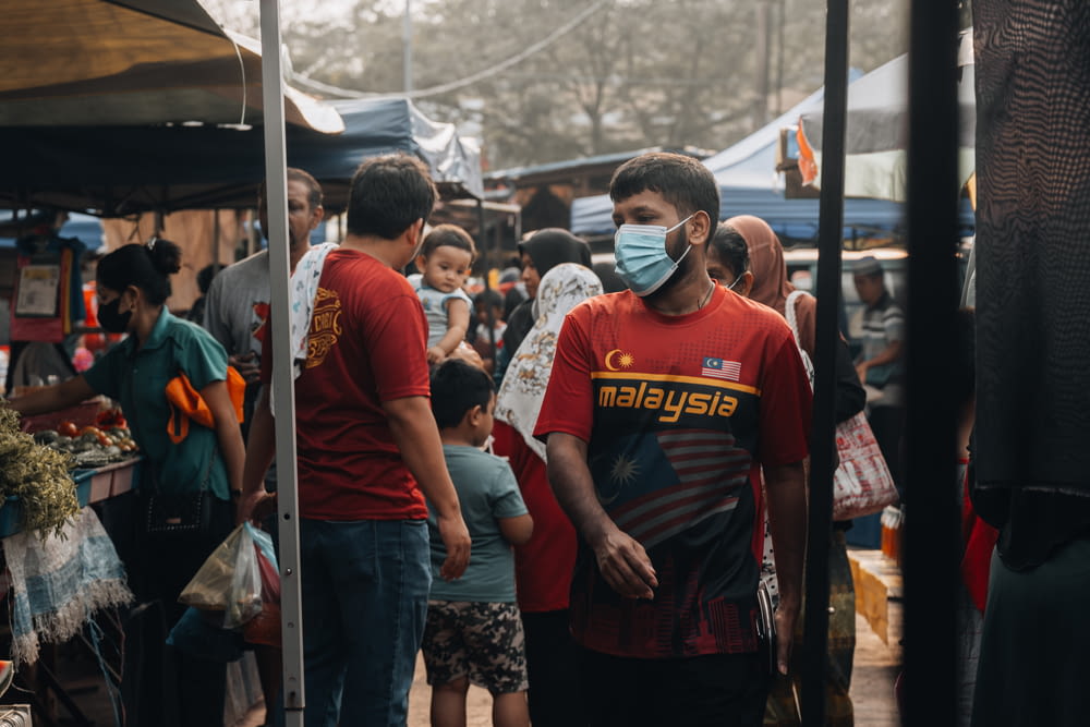 a group of people wearing face masks in a market