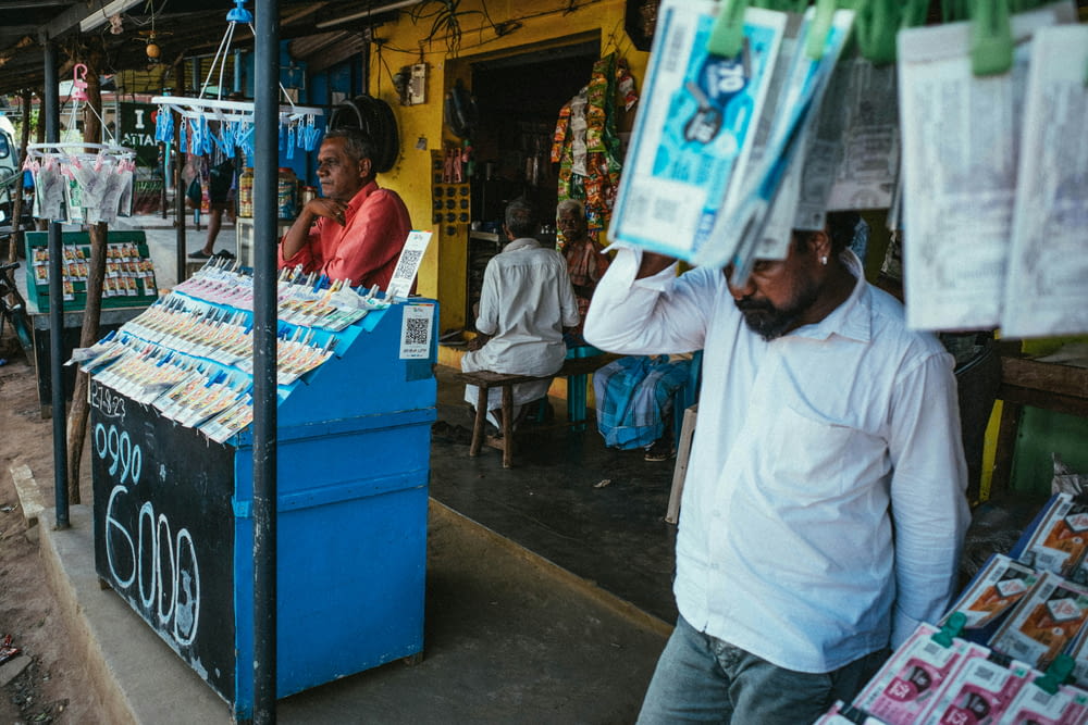 a man standing in front of a newspaper stand
