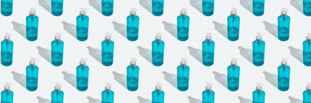 a group of blue bottles sitting next to each other