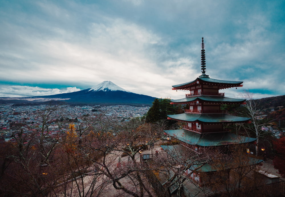 a tall pagoda with a mountain in the background