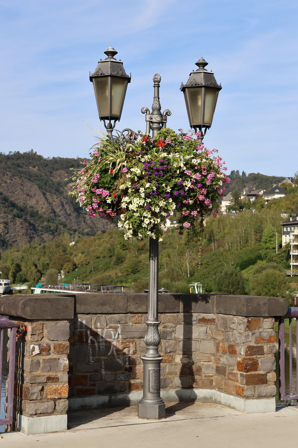 a lamp post with a bunch of flowers on it