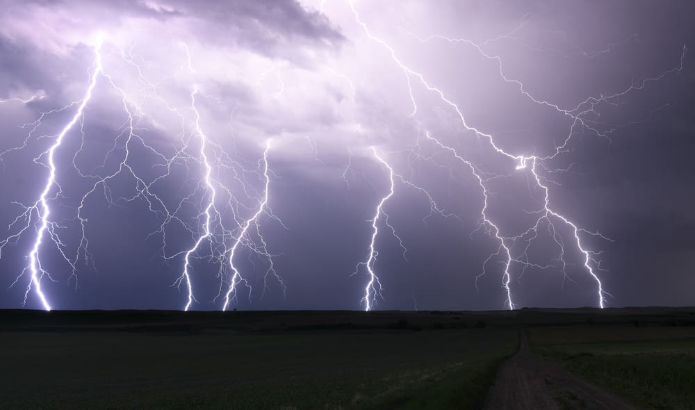 a bunch of lightning strikes over a field