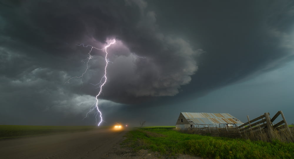 Ein Blitz schlägt über einem Bauernhof auf dem Land ein