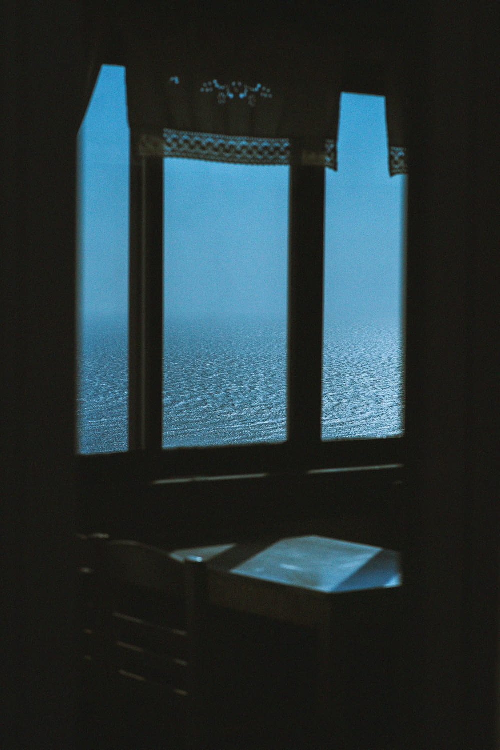 a window with a view of the ocean outside