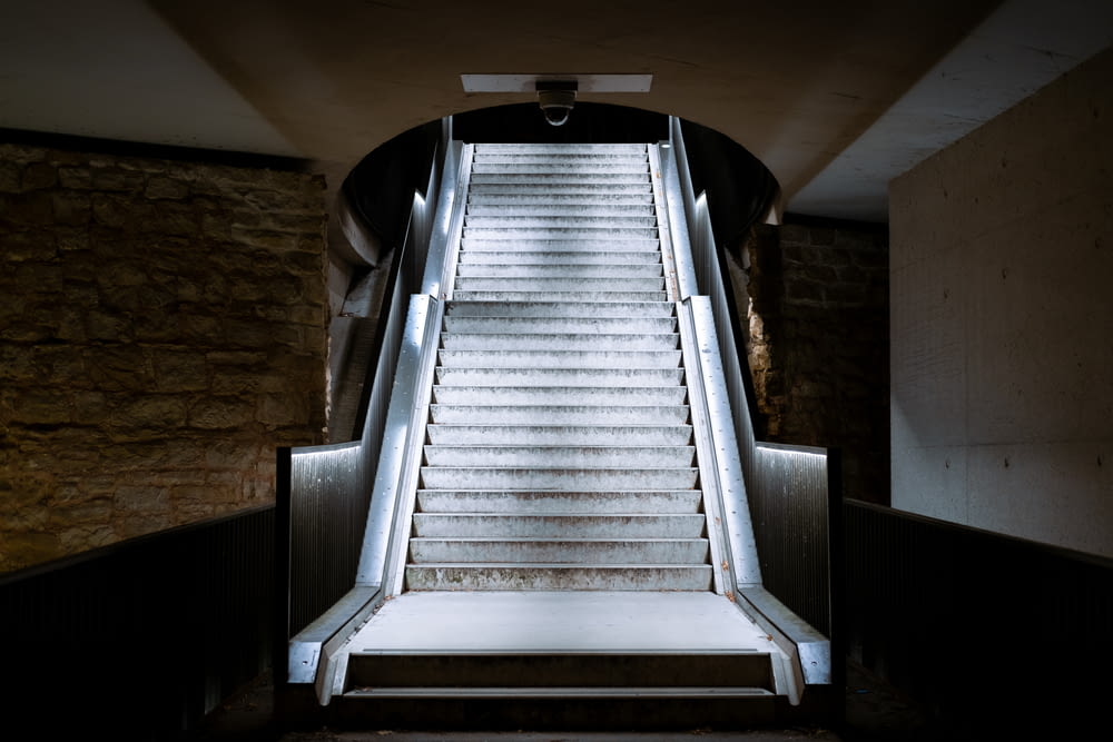 an escalator in a building with a metal handrail