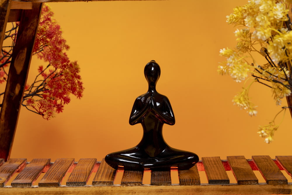a statue of a person sitting in a lotus position