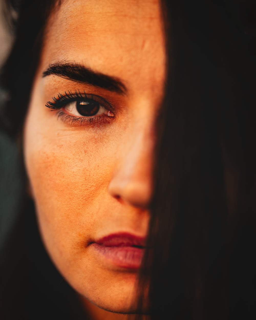 a close up of a woman's face with dark hair