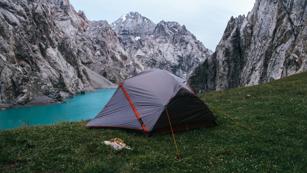 a tent pitched up on the side of a mountain