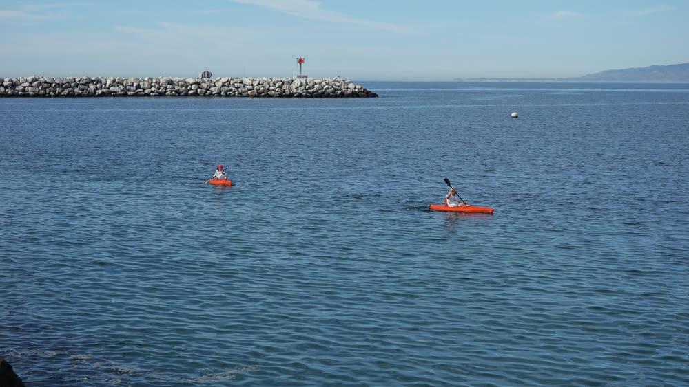 a couple of people in a kayak on a body of water