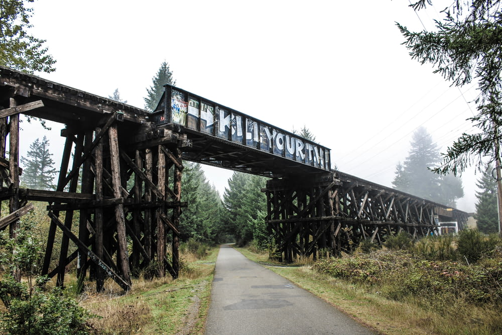 an old train bridge with graffiti on it