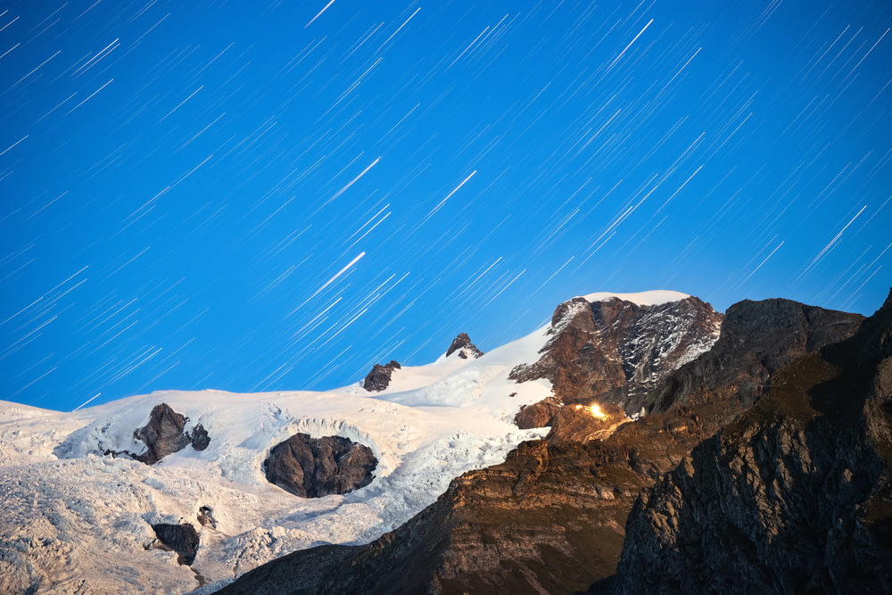 a snow covered mountain with stars in the sky
