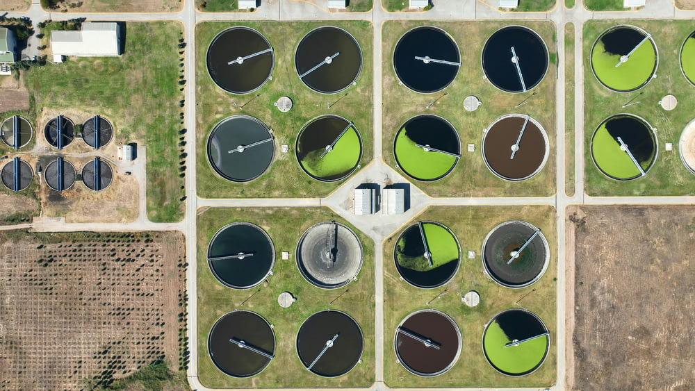 an aerial view of a field with a clock on it