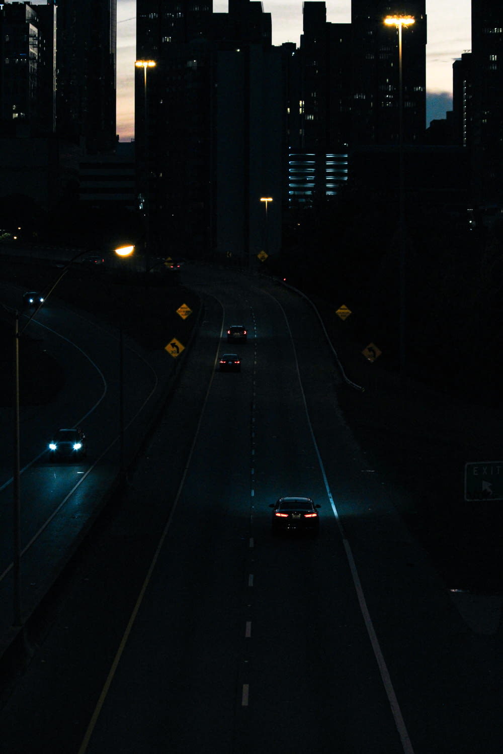 a car driving down a city street at night