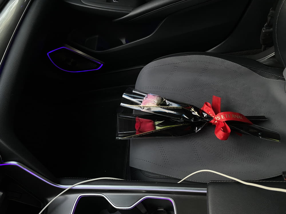 a bouquet of flowers sits in the center console of a car