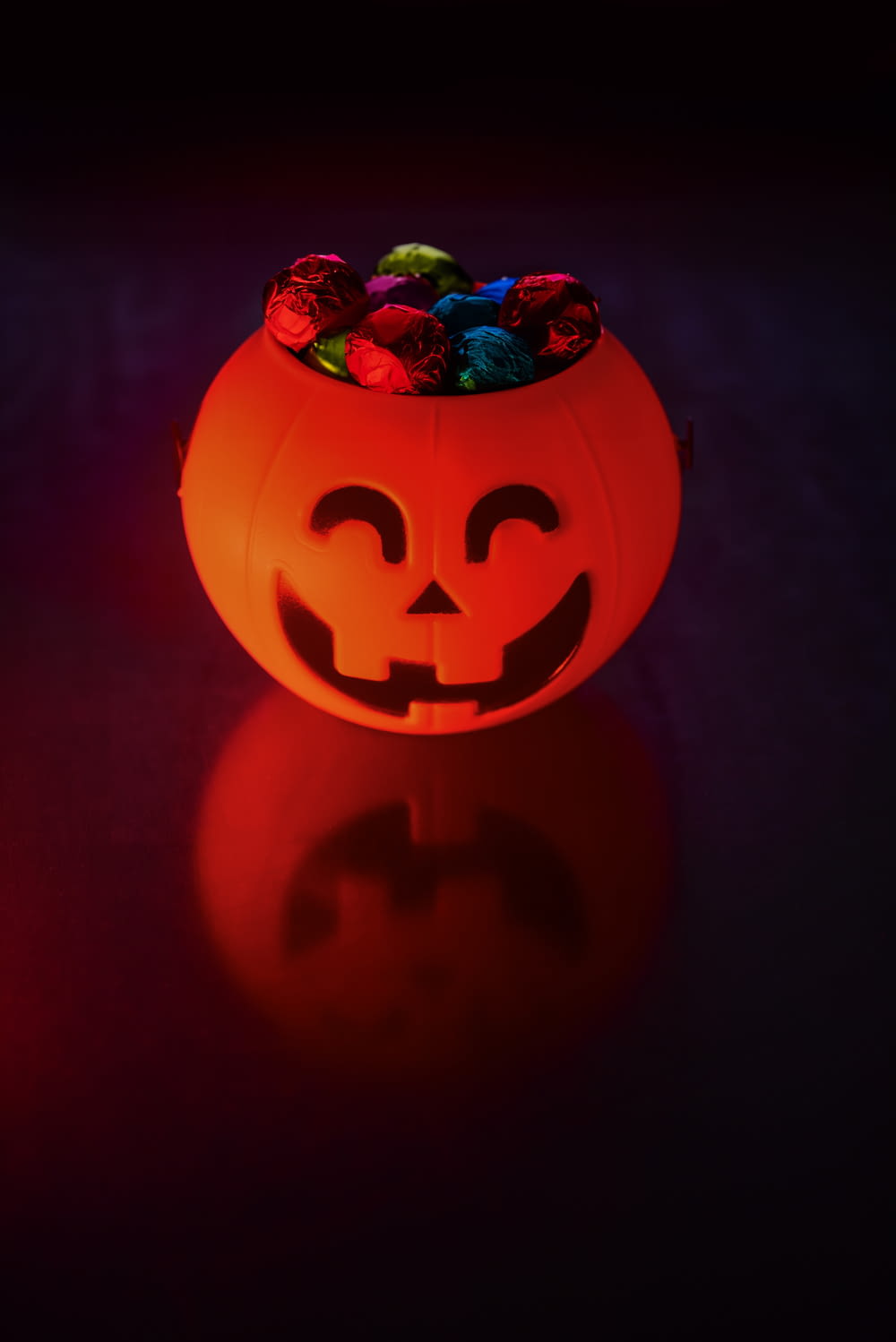 a pumpkin with candy in it sitting on a table