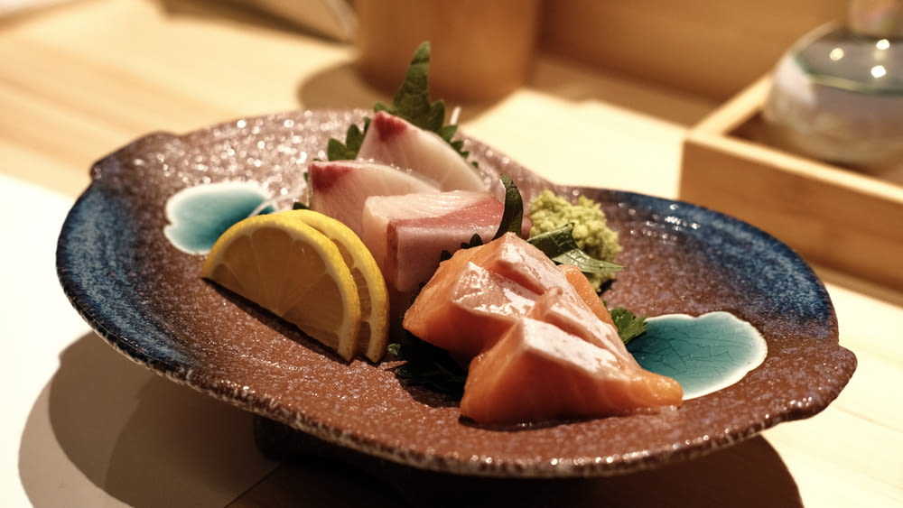 a plate of sashimi on a table