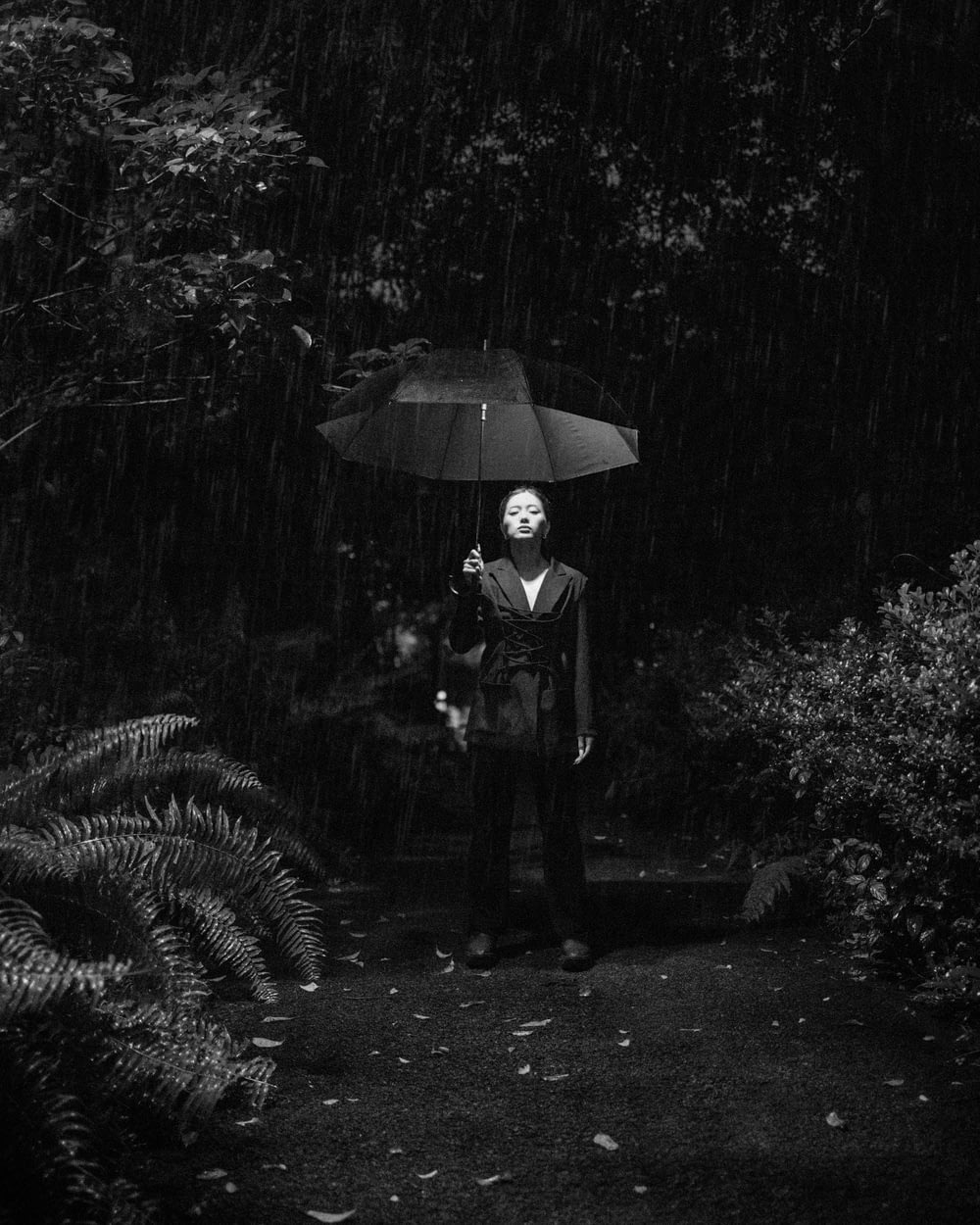 a woman holding an umbrella in the rain