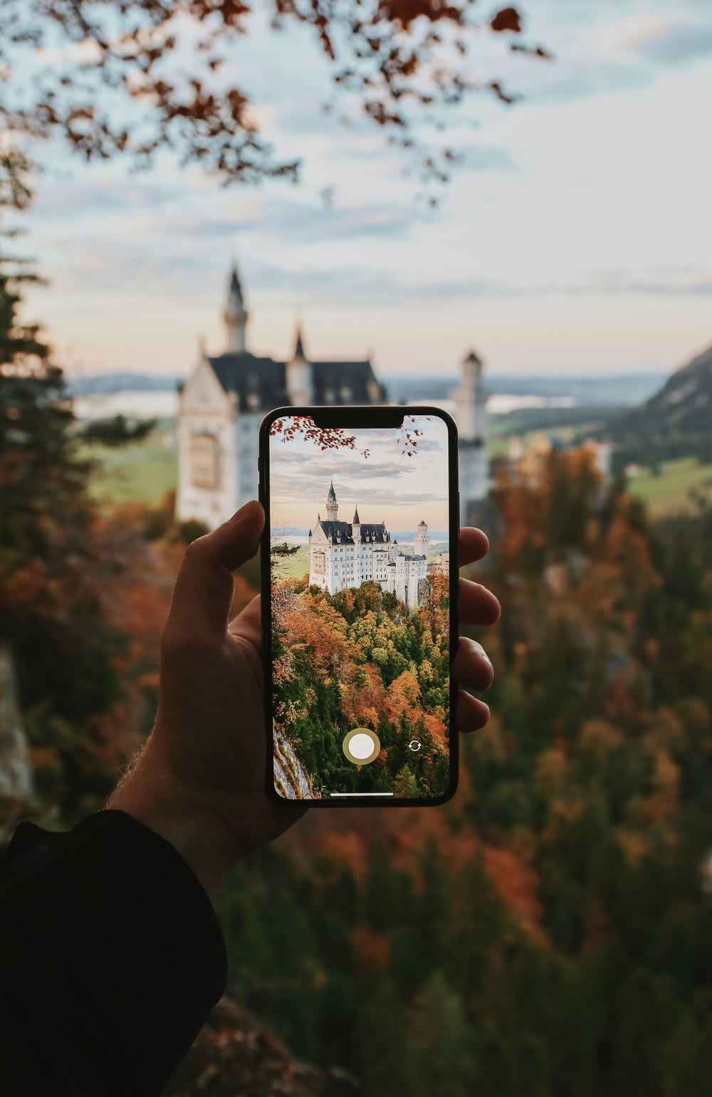 a person taking a picture of a castle
