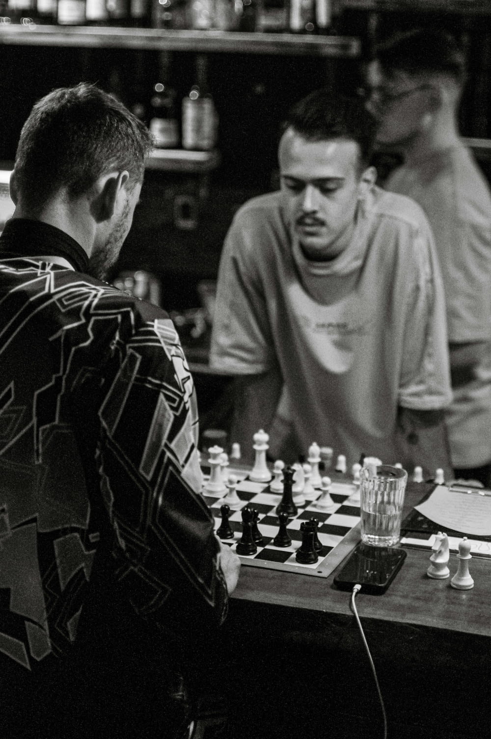 a group of men playing a game of chess