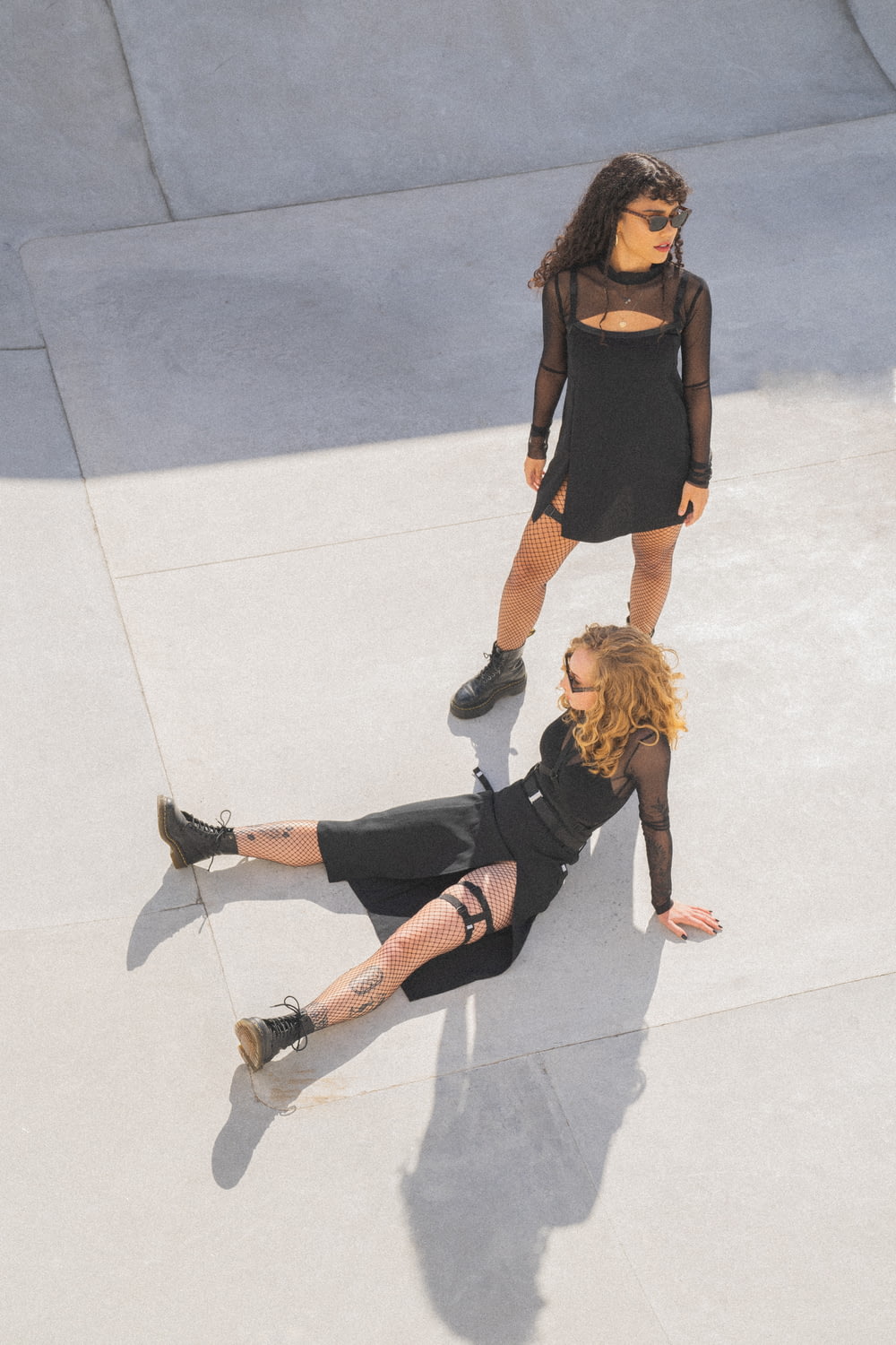 a woman laying on the ground next to another woman
