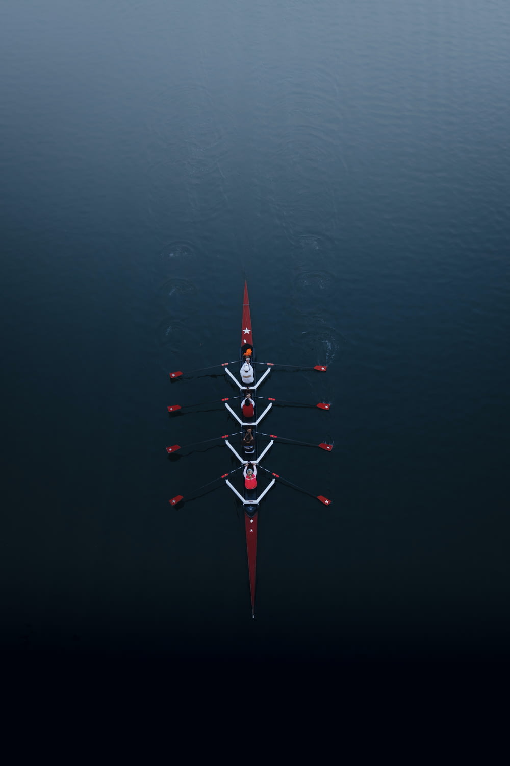 a row of boats floating on top of a body of water
