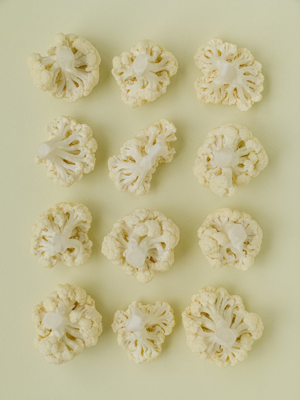 a bunch of cauliflower on a white surface