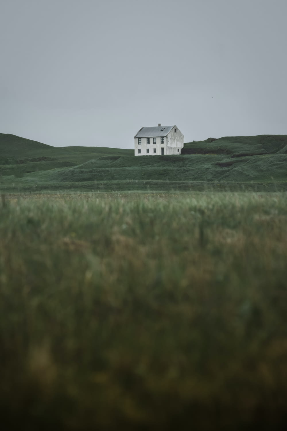 a white house in a field of green grass