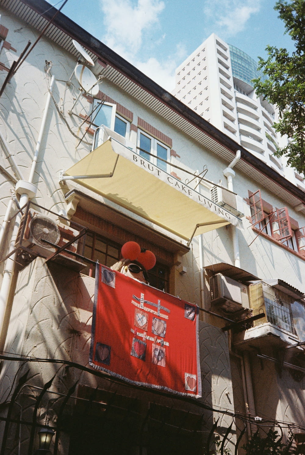 a building with a red sign hanging from the side of it