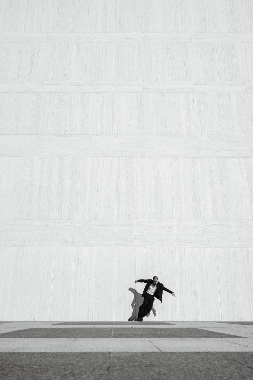 a man riding a skateboard across a cement floor