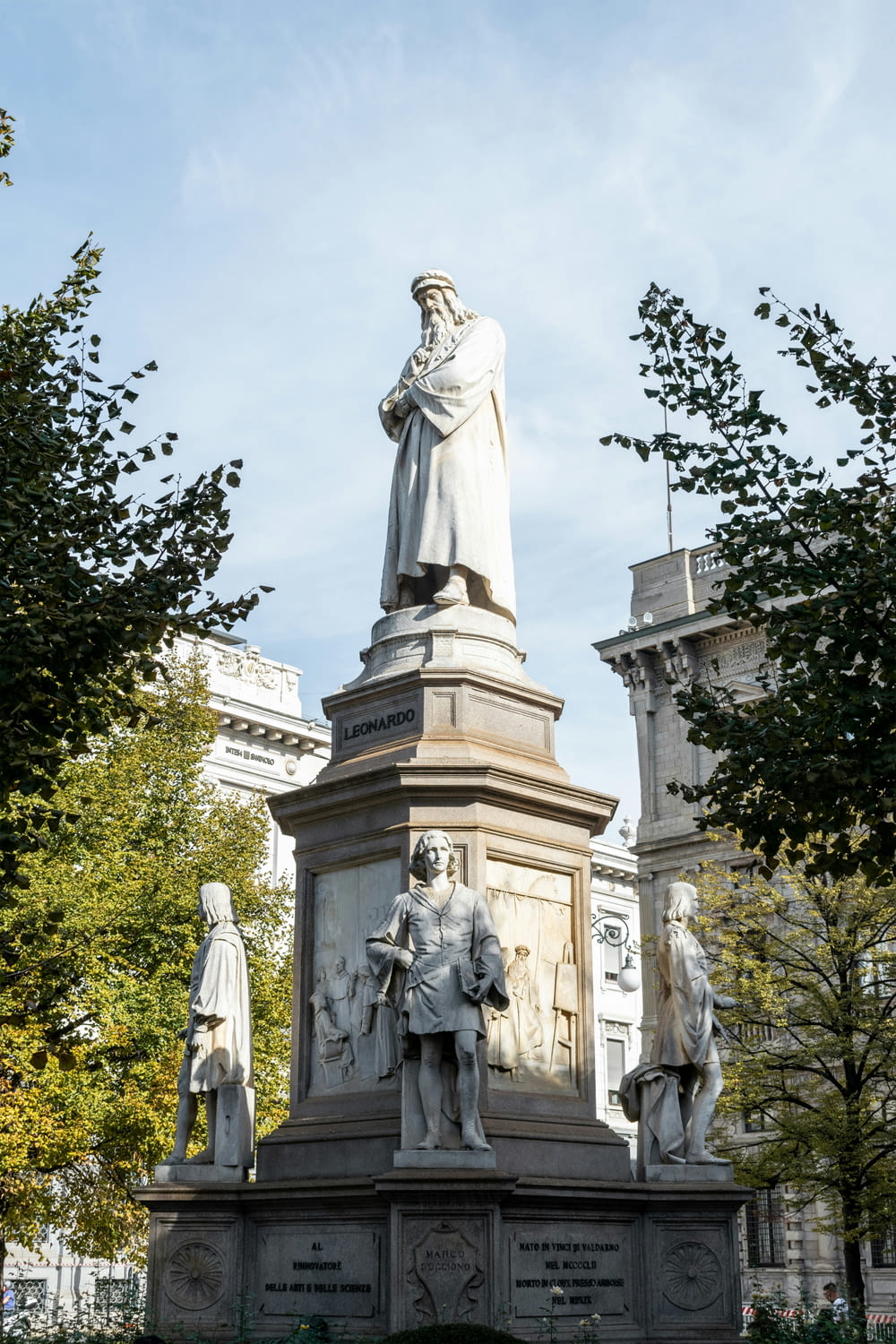 a statue of a man standing next to other statues