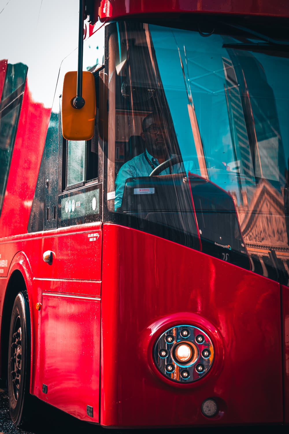 a red bus parked on the side of the road