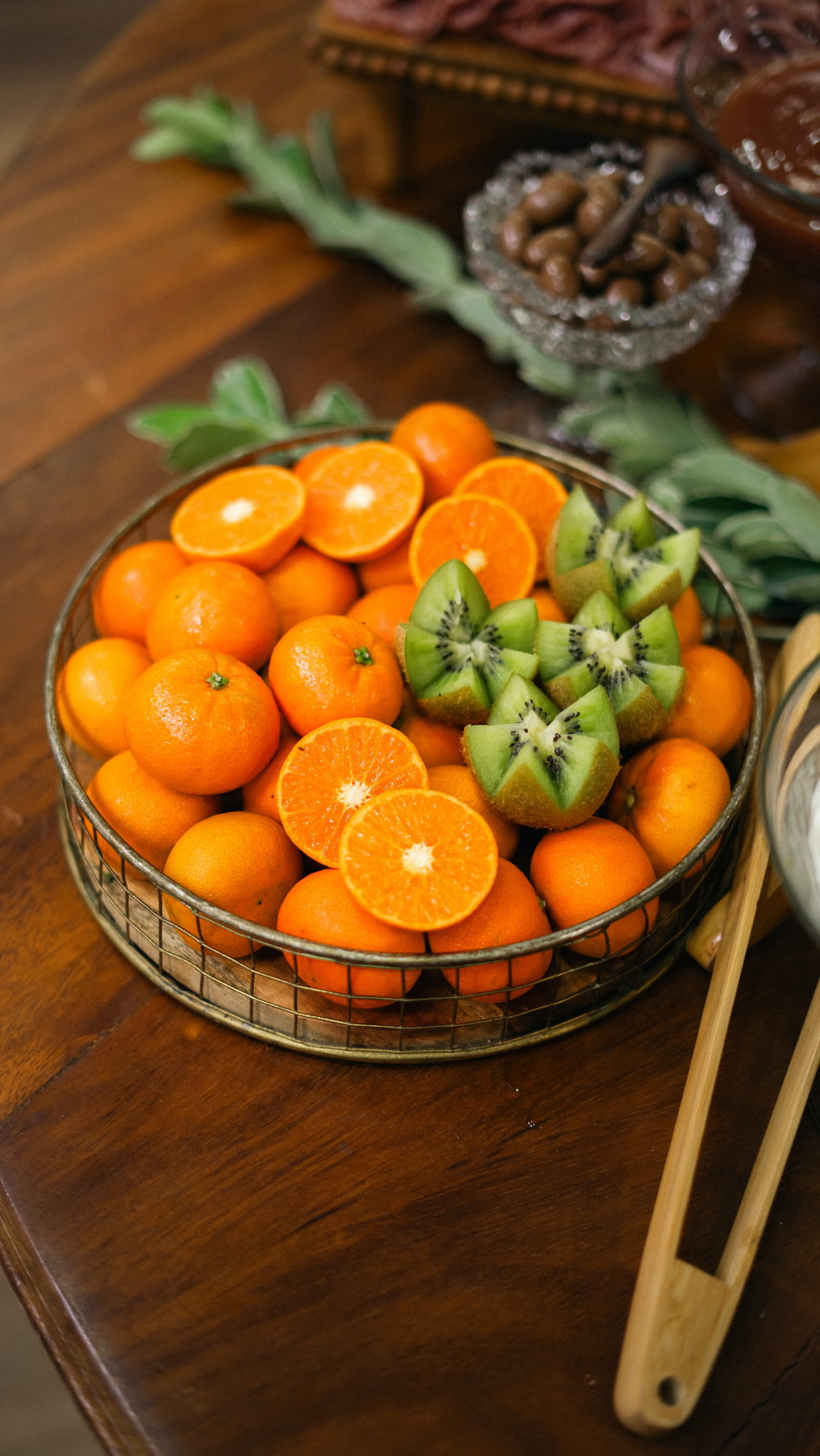a basket of oranges and kiwis on a table