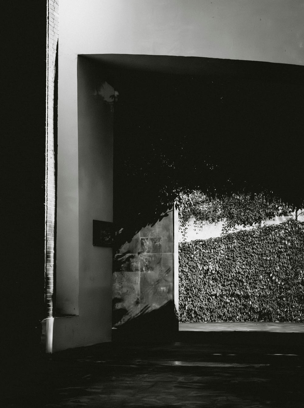 a black and white photo of a room with a door