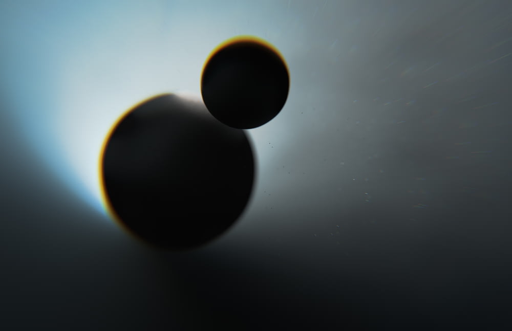 two black objects are shown in the sky