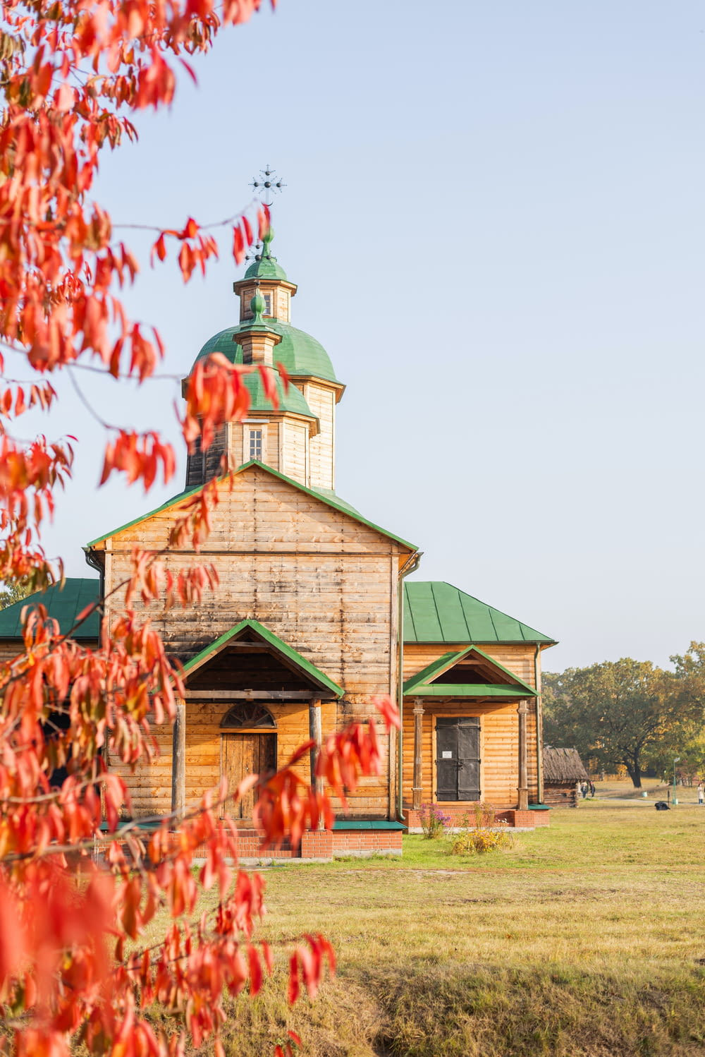 an old wooden church with a green roof