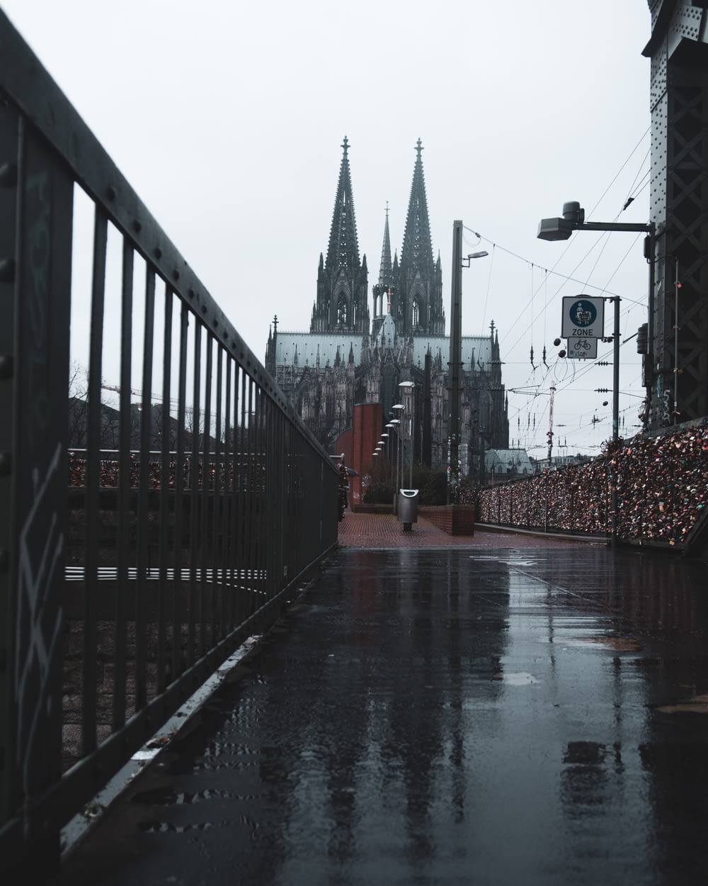 a large cathedral towering over a city on a rainy day