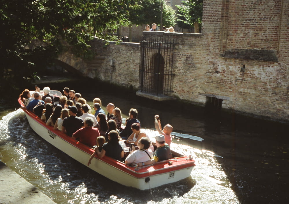 a group of people riding in a boat down a river