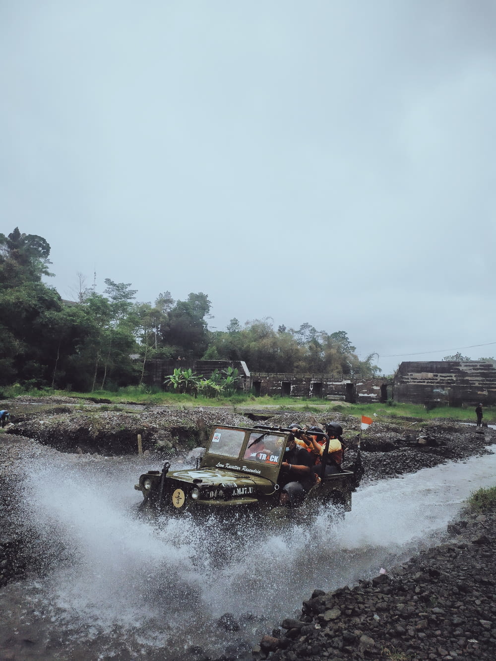 a jeep driving through a river filled with water