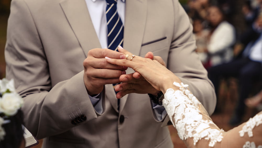 a bride and groom holding hands during a wedding ceremony