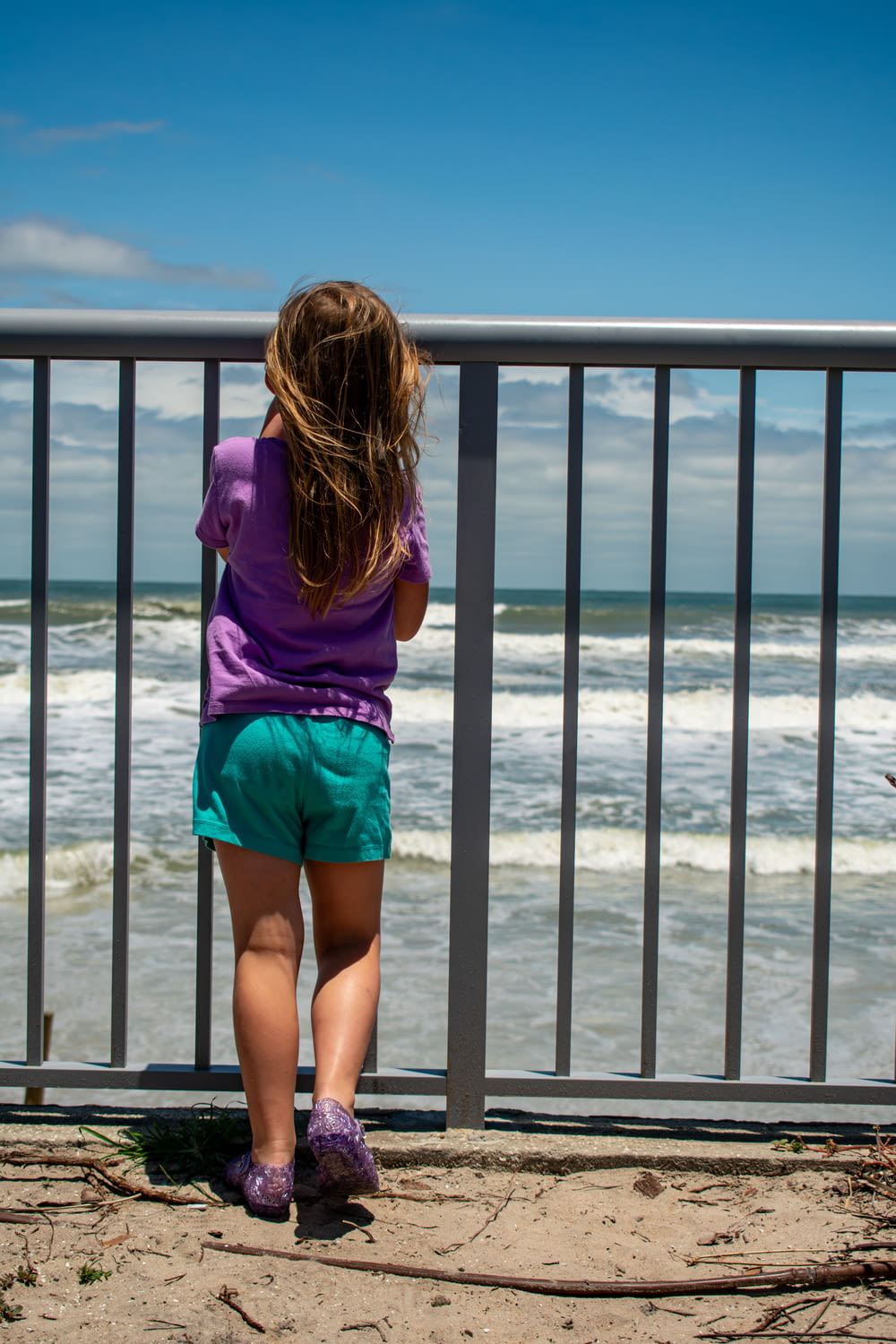 a little girl looking out at the ocean