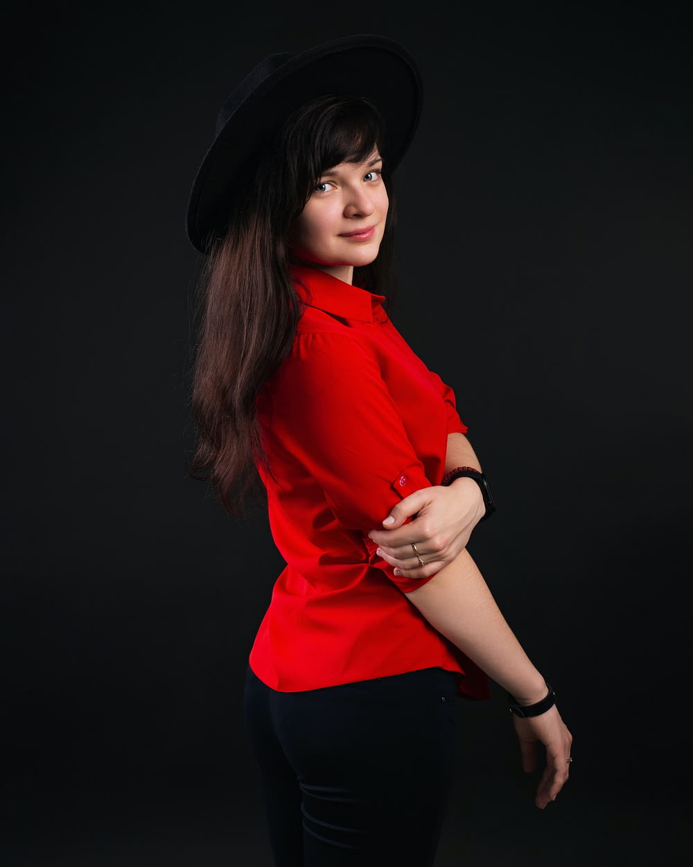 a woman in a red shirt and black hat
