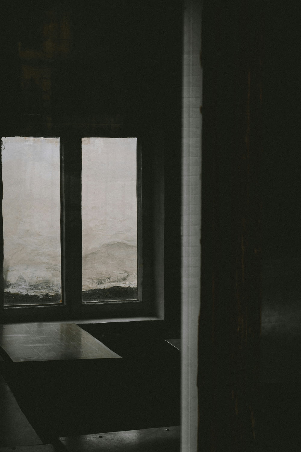 a room with a table and a window with a view of a body of water