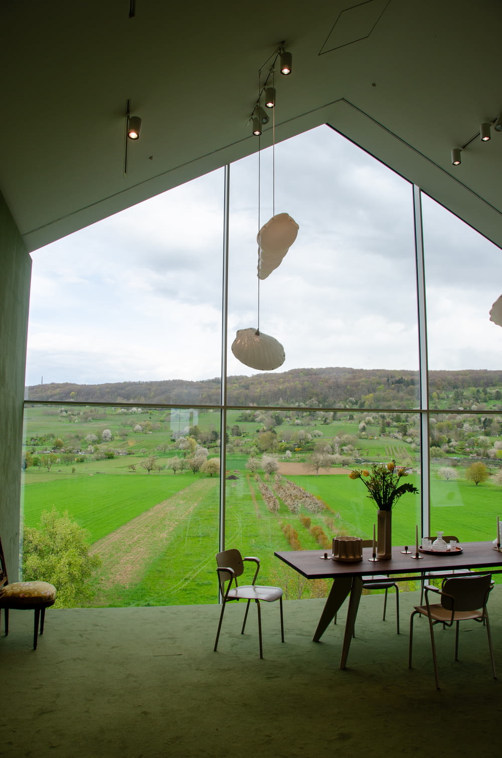 a dining room with a view of a green field