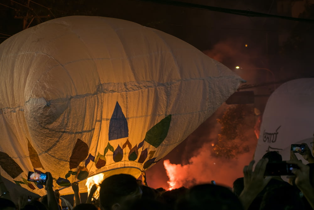 a group of people standing around a large hot air balloon