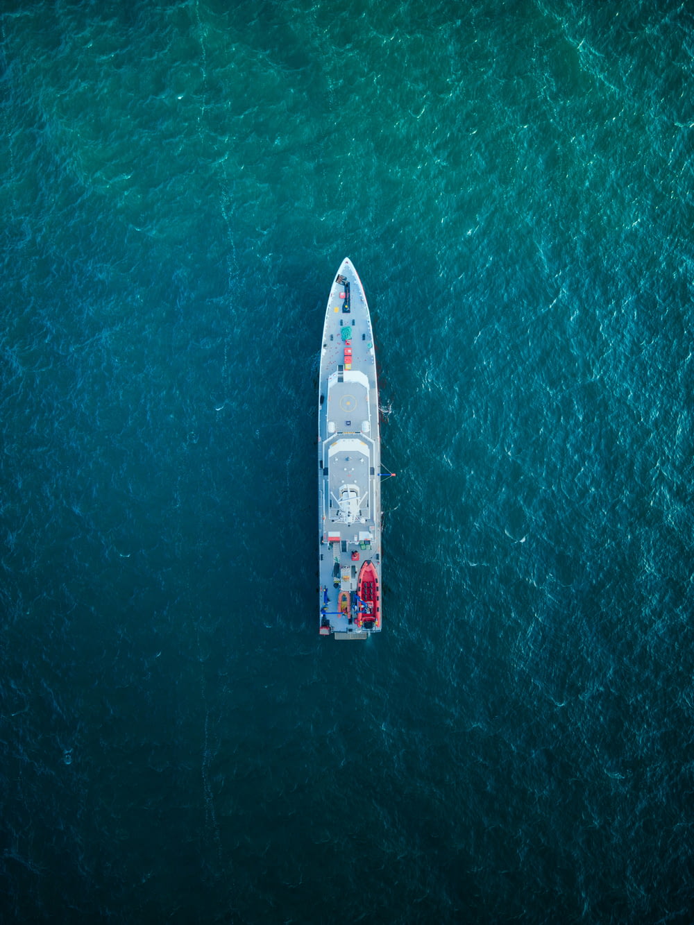 a small boat in the middle of the ocean