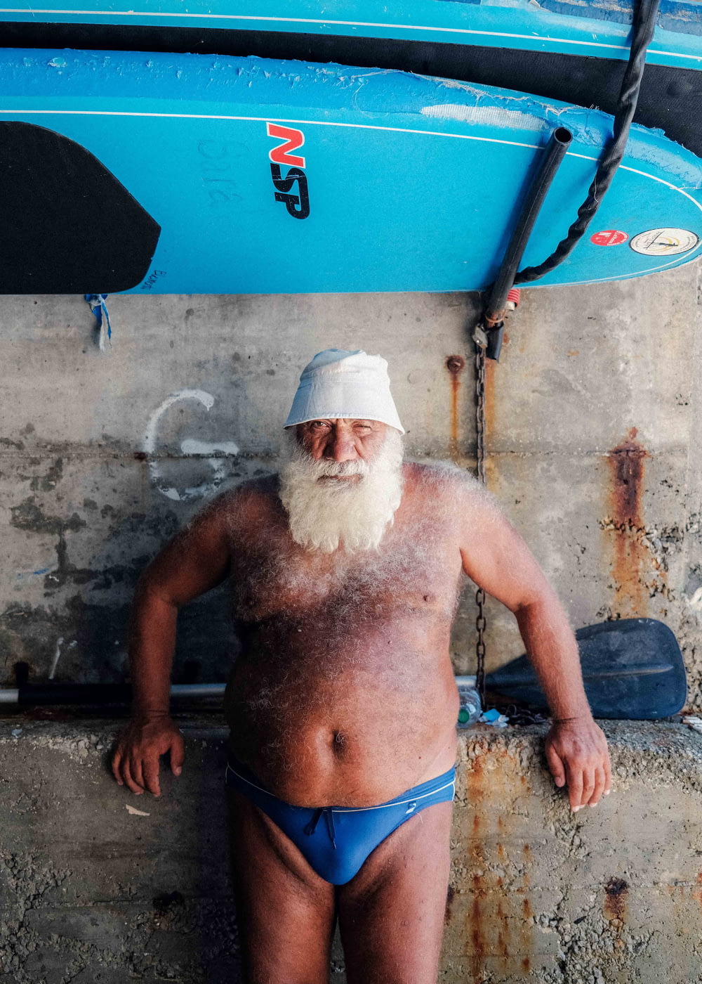 a man with a white beard wearing a blue swimsuit