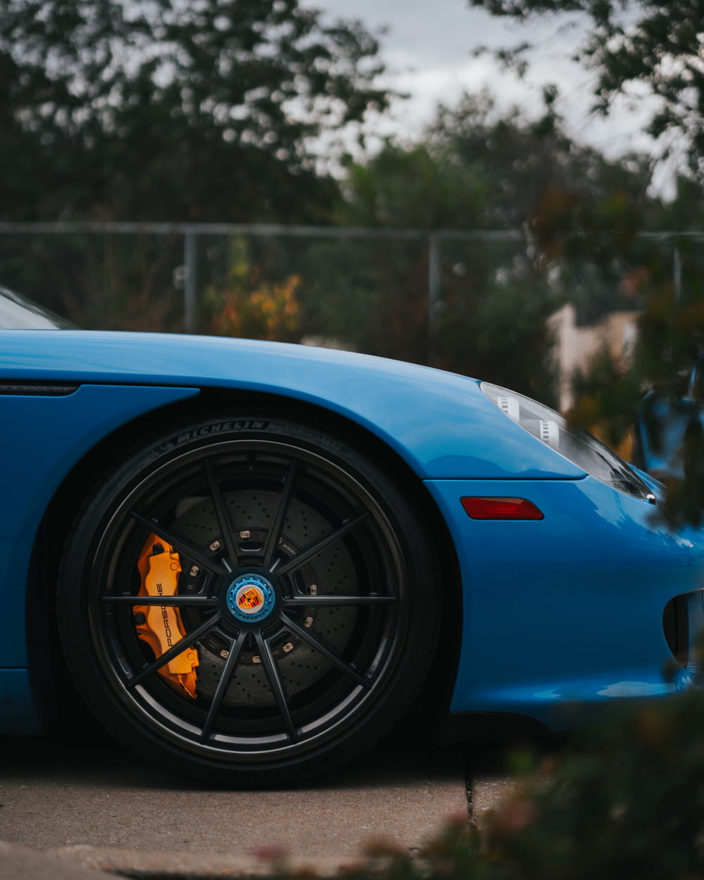 a blue sports car parked on the side of the road