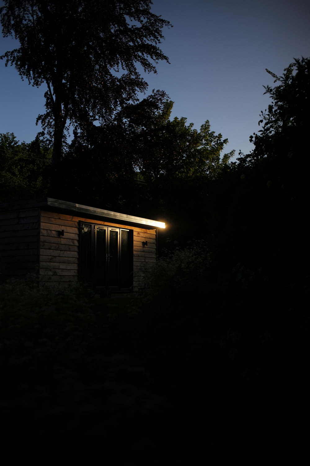a small building with a light on at night